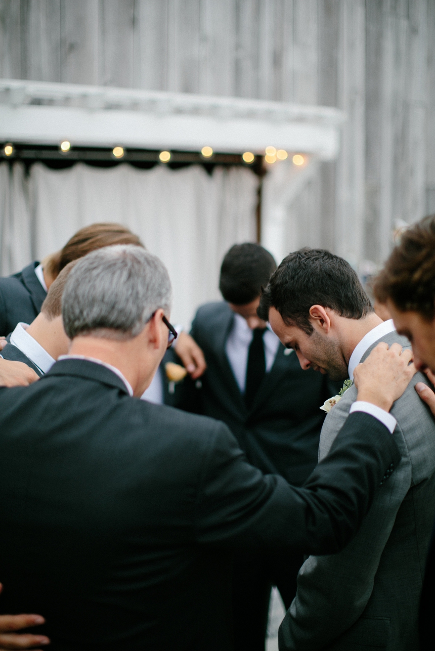 groomsmen praying wedding photos